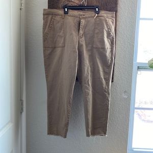 Tan crop pants with fringed legs. One belt loop is broken.